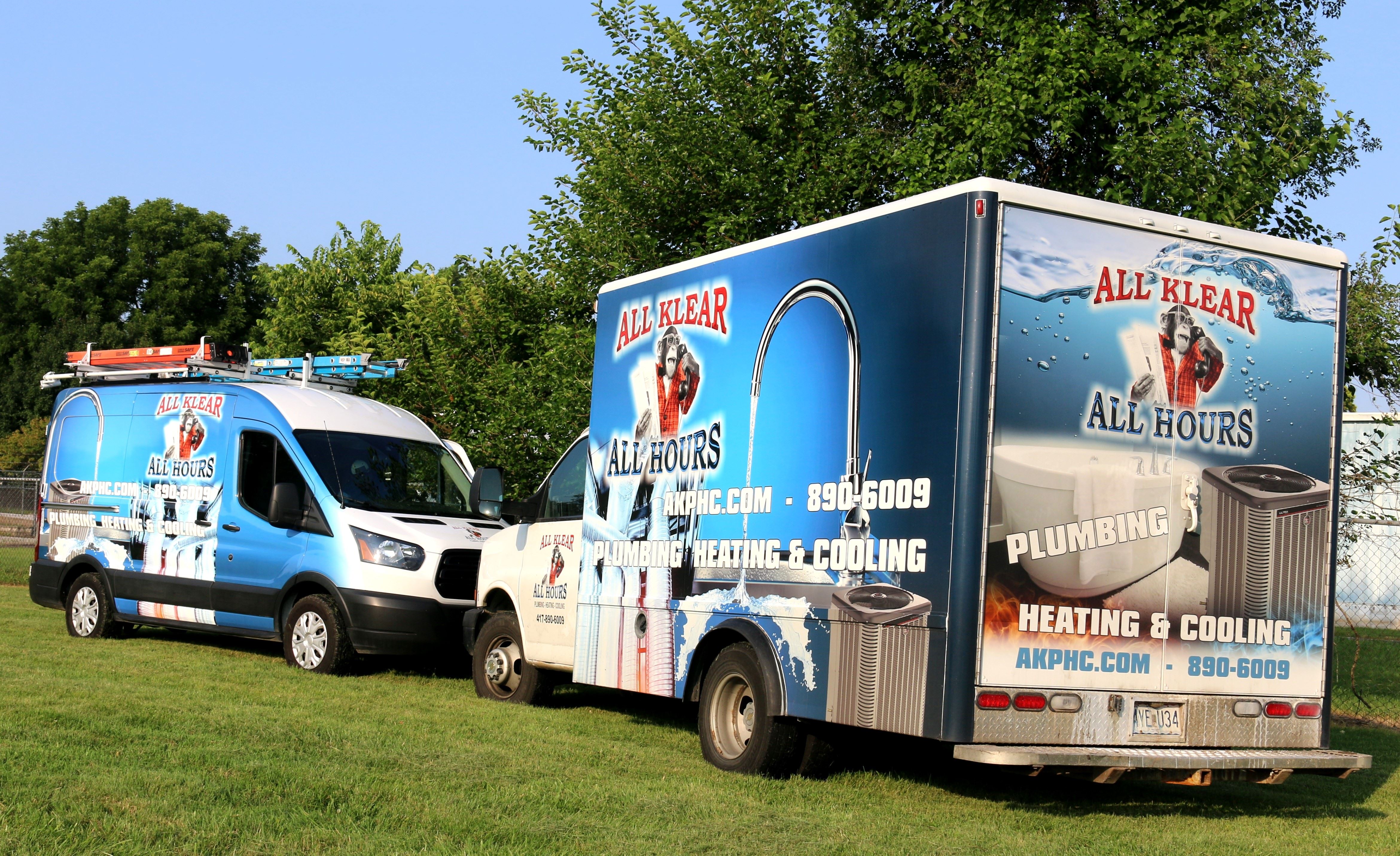 All Klear, Plumbing, Heating and Cooling Trucks facing each other