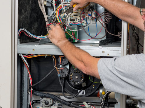 An HVAC tech checks the furnace in Springfield, MO
